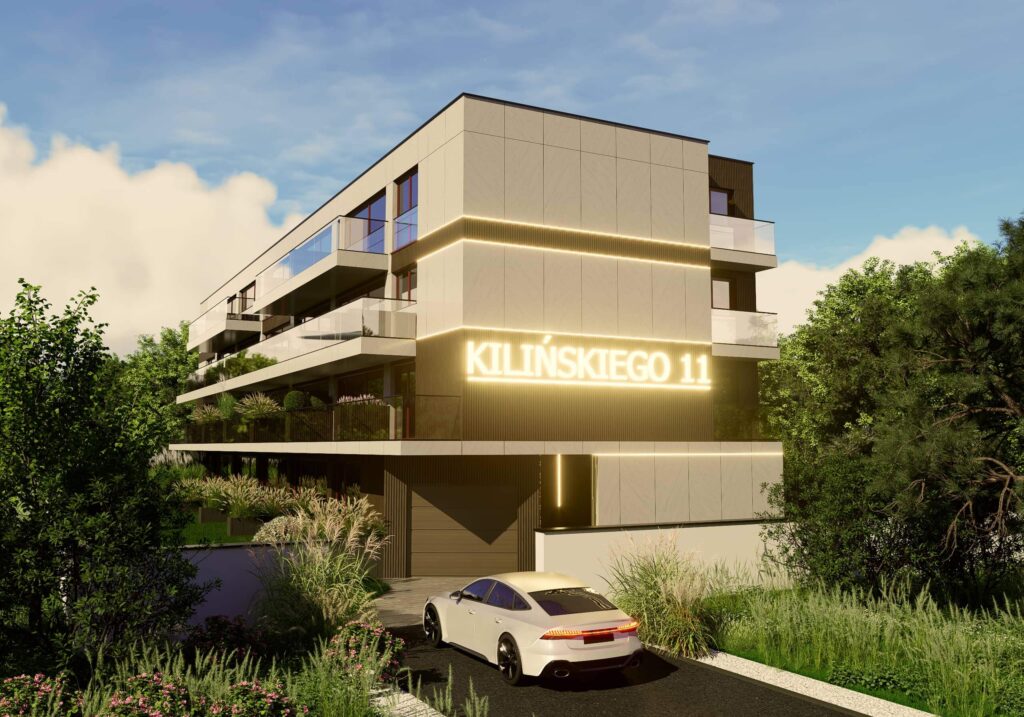 Wizualizacja nowoczesnego, kilkupiętrowego budynku mieszkalnego o nazwie „Kilińskiego 11”. Obiekt ma jasną elewację z poziomymi liniami podświetlenia LED oraz duże balkony ze szklanymi balustradami. Na bocznej ścianie umieszczono duży, świecący napis z nazwą inwestycji. Przed budynkiem, na asfaltowym podjeździe, stoi biały samochód osobowy tyłem do widza. Całość otacza zadbana zieleń – wysokie trawy ozdobne, krzewy oraz drzewa podświetlone światłem słonecznym.